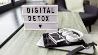 "Digital Detox" sign with electronic devices on a table.