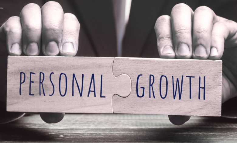 Hands holding two puzzle pieces with "PERSONAL GROWTH" written on them.