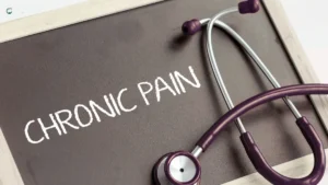 Stethoscope placed beside a chalkboard with "Chronic Pain" written on it, symbolizing the psychological effects of persistent pain