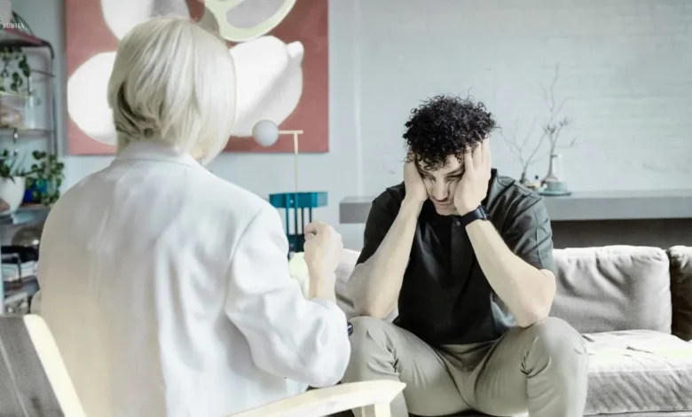 A distressed man in a therapy session expressing emotions to a counselor, symbolizing the role of therapy in emotional release.