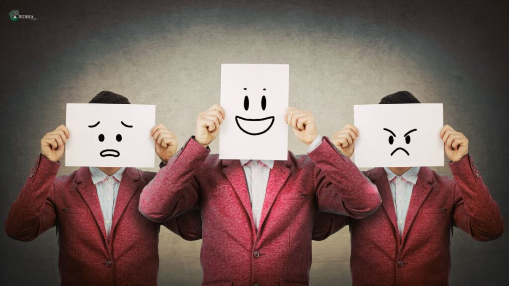 People holding different emotional faces to show emotional intelligence.