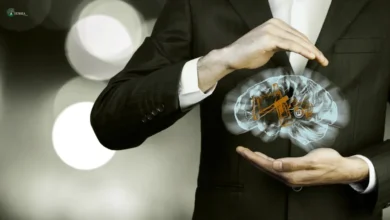A businessman holding a digital brain model, representing the psychology of habit formation and how the brain builds and breaks habits.