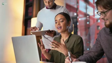 Young professionals multitasking during a meeting, highlighting how constant digital distractions impact focus at work