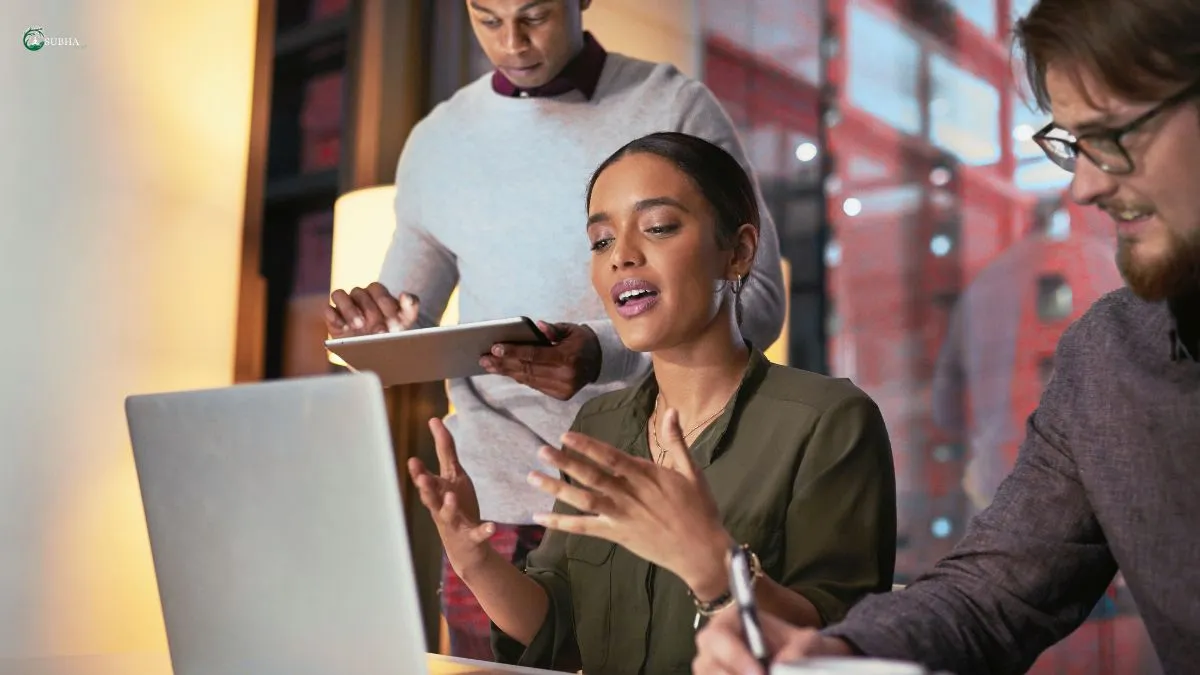 Young professionals multitasking during a meeting, highlighting how constant digital distractions impact focus at work