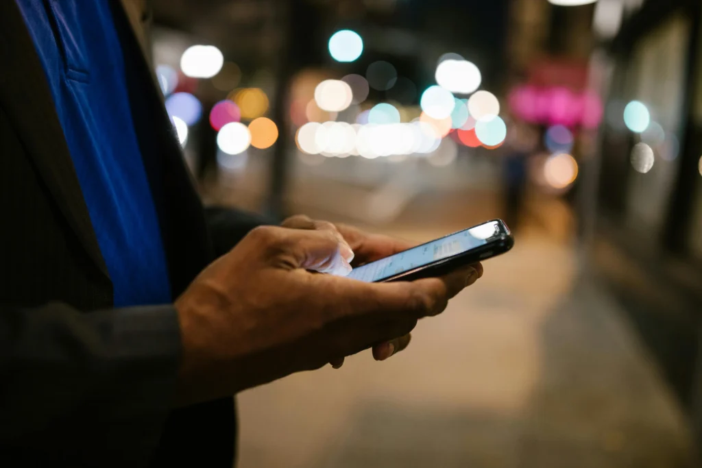 Man chatting on smartphone, illustrating AI Chatbots vs Therapists in online counseling and support.