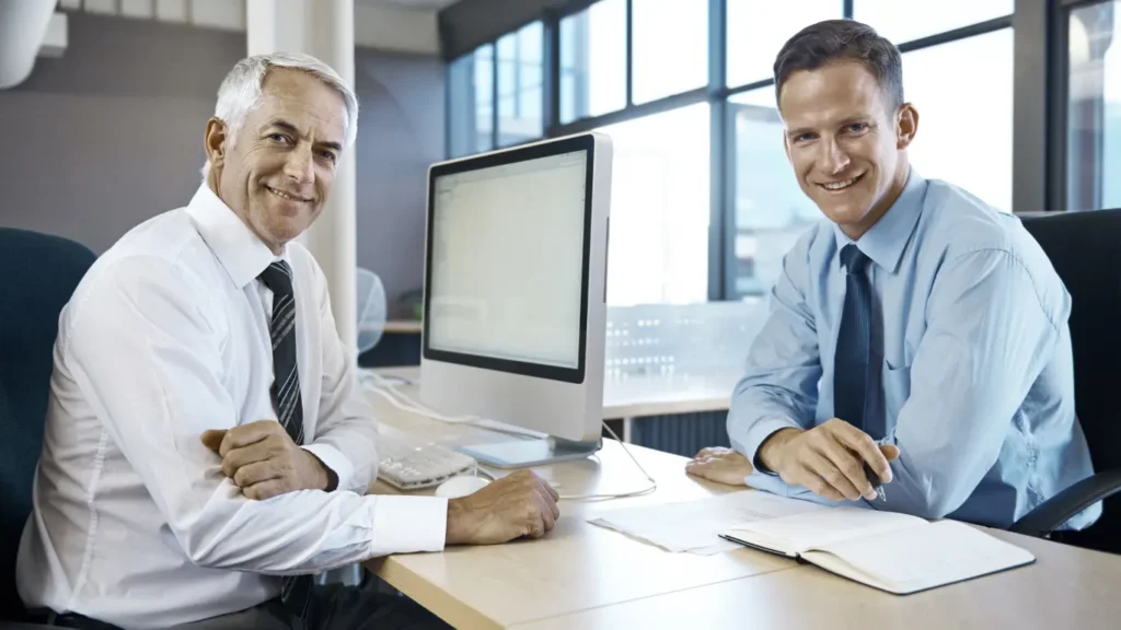 Businessmen discussing mental health myths and AI solutions in office