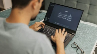 Person using an AI chatbot on laptop – concept of AI Chatbots vs Therapists in mental health support.